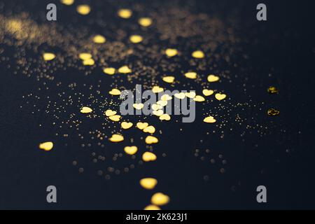 Dark blue background with golden glitter and hearts confetti Stock Photo
