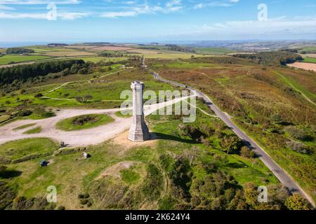 Portesham, Dorset, UK.  11th October 2022.  UK Weather.  View from the air of Hardy Monument on Black Down near Portesham in Dorset on a warm clear sunny autumn afternoon.  The monument is 72 foot high and was erected in 1844 by public subscription in memory of Vice Admiral Sir Thomas Masterman Hardy, flag captain of Admiral Lord Nelson at the Battle of Trafalgar. Picture Credit: Graham Hunt/Alamy Live News Stock Photo