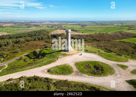 Portesham, Dorset, UK.  11th October 2022.  UK Weather.  View from the air of Hardy Monument on Black Down near Portesham in Dorset on a warm clear sunny autumn afternoon.  The monument is 72 foot high and was erected in 1844 by public subscription in memory of Vice Admiral Sir Thomas Masterman Hardy, flag captain of Admiral Lord Nelson at the Battle of Trafalgar. Picture Credit: Graham Hunt/Alamy Live News Stock Photo