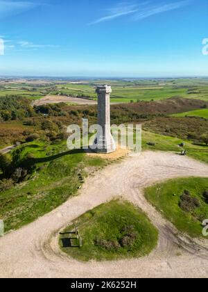 Portesham, Dorset, UK.  11th October 2022.  UK Weather.  View from the air of Hardy Monument on Black Down near Portesham in Dorset on a warm clear sunny autumn afternoon.  The monument is 72 foot high and was erected in 1844 by public subscription in memory of Vice Admiral Sir Thomas Masterman Hardy, flag captain of Admiral Lord Nelson at the Battle of Trafalgar. Picture Credit: Graham Hunt/Alamy Live News Stock Photo