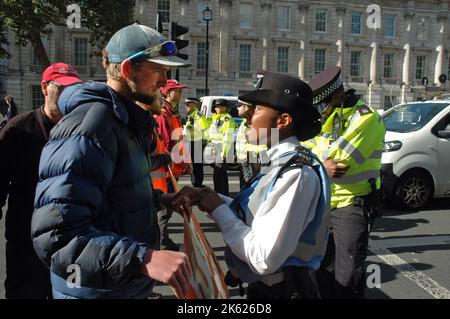 London, UK. 11th Oct, 2022. Just Stop Oil block traffic in Whitehall outsided Downing Street. Credit: JOHNNY ARMSTEAD/Alamy Live News Stock Photo