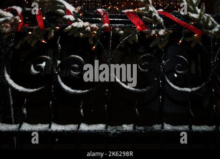 Cast iron fence pattern with Christmas holiday decorations in Ridgewood New York Stock Photo