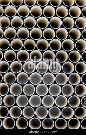 Macro shot of black drinking straws from end on. Stock Photo