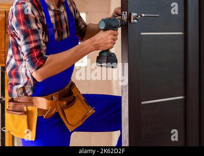 Close up of a mans hand holding screwdriver machine Stock Photo