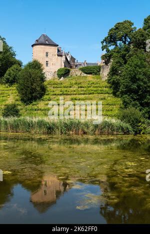 Lennik, Flemish Brabant Region, Belgium - 07 20 2021 - The Gaasbeek medieval castle reflecting in a water pond Stock Photo