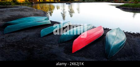 Canoes boats near lake in mountains wilderness for recreation Stock Photo