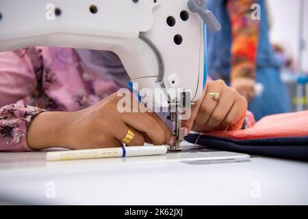 WOMAN STITCHING Stock Photo