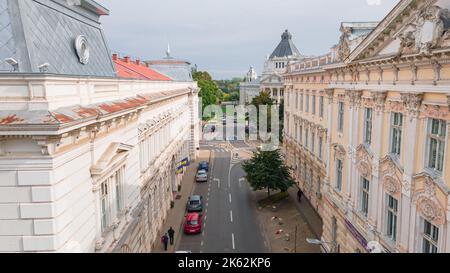 Aerial photography shot from a drone at a low altitude just over a road, between city hall and Aurel Vlaicu University Stock Photo