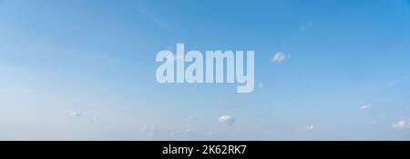 Blue panoramic sky background with small white clouds Stock Photo