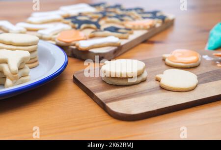 Process of decorating cookies with different shapes for Halloween. Homemade pastry. Copy space. Stock Photo