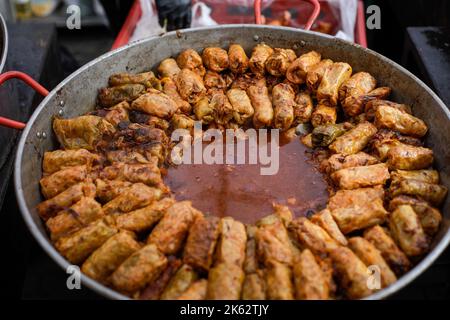 Shallow depth of field (selective focus) details with a big pot of sarmale, Romanian traditional cabbage rolls filled with minced meat, in a farmers m Stock Photo