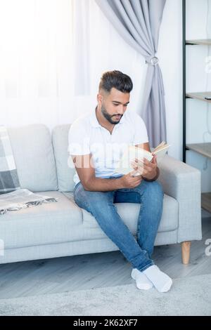 home reading relaxed man enjoying time arabian guy Stock Photo