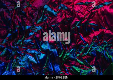 creased foil texture neon background pink blue Stock Photo