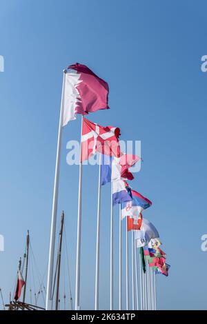 Flags of nations qualified for World Cup Qatar 2022 hoisted at Doha Corniche, Qatar. Stock Photo