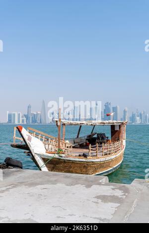 Traditional dhow on a background of a modern city of Doha Corniche, Doha, Qatar. Stock Photo