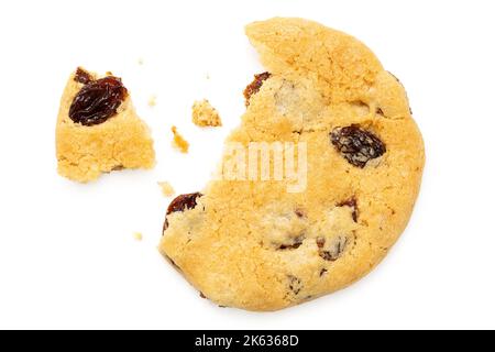 Partially eaten all butter sultana cookie with crumbs isolated on white. Top view. Stock Photo
