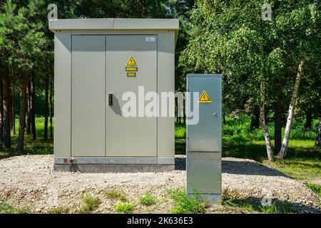 New modern outdoor electric high voltage distribution cabinet next to low voltage distribution cabinet Stock Photo