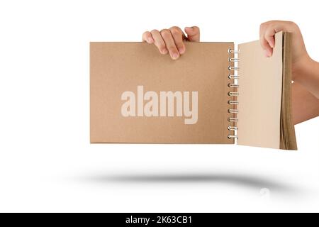 Notepad isolated on white background. Brown notepad made from recycled paper on a white background in the hands of a child Stock Photo