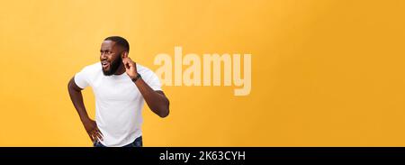 Headshot of goofy surprised bug-eyed young dark-skinned man student wearing casual white t-shirt staring at camera with shocked look. Stock Photo