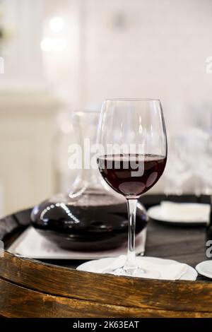 Red wine bottle and glass on Old wooden barrel, Tuscany Italy. Stock Photo