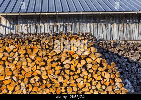 Stack of split logs for domestic heating fuel - Le Petit-Pressigny, Indre-et-Loire (37), France. Stock Photo