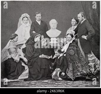 Queen Victoria shown with members of her family shortly after the wedding of the Prince and Princess of Wales, with a mourning bust of her late husband in the centre. (left) Prince Albert. Edward, Prince of Wales with his new wife, Alexandra. Seated to the left is Princess Louise. The Queen wearing widow's cap, reading to her youngest child, Princess Beatrice while Prince Leopold kneels on the floor. Princess Helena stands next to her brother-in-law, Grand Duke Louis of Hesse, and his wife, Princess Alice sits by his side. Groups like this emphasised Prince Albert's continued presence but in f Stock Photo