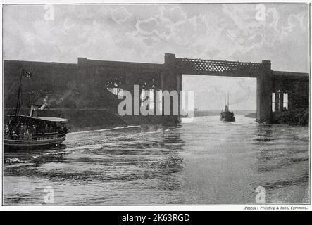 Construction of a canal (36-mile-long) for seagoing ships between the city of Manchester and the estuary of the Mersey had proved to be an engineering undertaking of the first magnitude. Photograph showing the high railway which carries the Cheshire Lines across the Canal at the height of 75 feet above water. Stock Photo