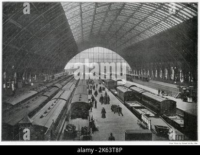 Interior of St. Pancras Railway Station, showing the magnificent canopy dwarfing the trains beneath. Stock Photo