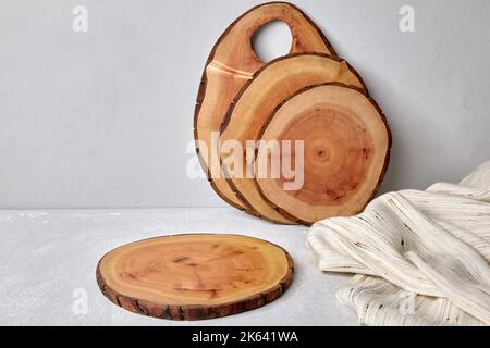 Kitchen space with wooden cutting boards and tea towel on a light concrete table for food presentation Stock Photo