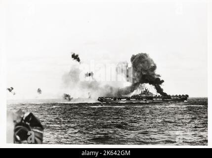 World War II vintage photograph - fire on USS Intrepid aircraft caarrier after near miss from Japanese aircraft suicide attack Stock Photo