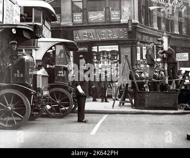 c.1930's street scene in London with bus and policeman Stock Photo