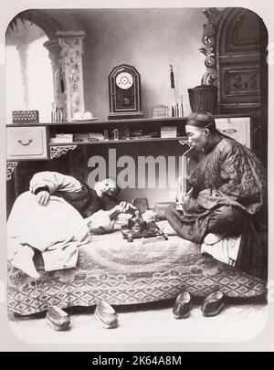 Vintage late 19th century photograph: Opium smokers, drug taking, pipes,  China Stock Photo