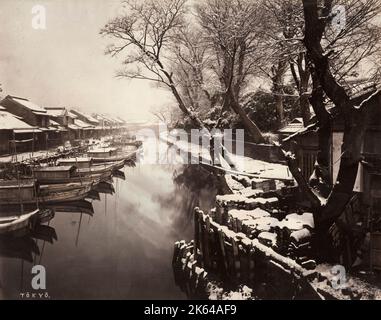 19th century vintage photograph - snow scene with boats along a canal in Tokyo, Japan, c.1880's Stock Photo