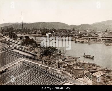Vintage 19th century photograph - Meiji era Japan: view of wharves along the waterfront of the town of Hiroshima Japan. Hiroshima, now a modern city on JapanÃ¢Â€Â™s Honshu Island, was largely destroyed by an atomic bomb during World War II. Stock Photo