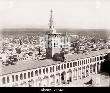 Vintage 19th century photograph: The Umayyad Mosque, also known as the Great Mosque of Damascus, with the city behind, Syria. Stock Photo