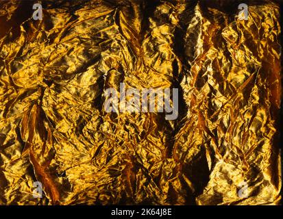 grunge overlay crushed foil texture golden film Stock Photo