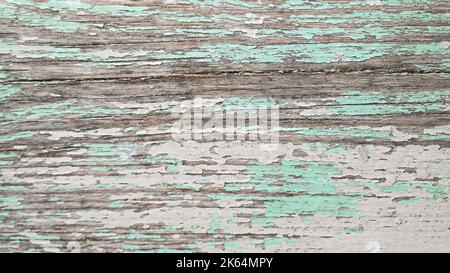 Texture of old cracked turquoise and pink paint in pastel tones on wooden surface. Horizontal background Stock Photo