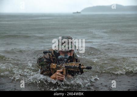 San Vicente, Philippines. 10 October, 2022. U.S. Marine Cpl. Jacob Konefsky, a rifleman with 1st Battalion, 2d Marines, comes ashore during reconnaissance for a combined amphibious raid with Philippine Marines during KAMANDAG 6, October 10, 2022 in San Vicente, Philippines.  KAMANDAG 6 is a combined exercise with the Philippine Marine Corps, South Korean Marine Corps, and the Japan Ground Self-Defense Force.  Credit: LCpl. Michael Taggart/U.S. Marine Corps/Alamy Live News Stock Photo