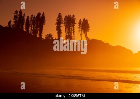 Joaquina Beach with rocks and ocean waves at sunrise in Brazil. Aerial ...