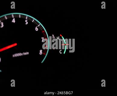 Car speedometer with a selective focus on a temperature gauge and blur background Stock Photo