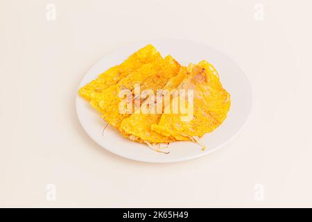 Banh xeo, Vietnamese Crêpes or Pancakes with pork, shrimp, onions, beasn sprouts inside, Vietnamese food isolated on white background. perspective vie Stock Photo