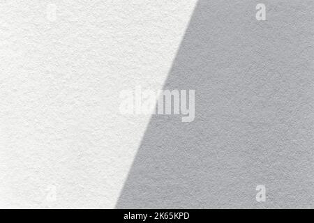 Texture of craft white and gray paper background, half two colors, macro. Structure of vintage dense kraft grey cardboard. Felt backdrop closeup. Stock Photo