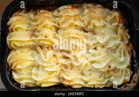 Shepherd's pie. Minced meat, mashed potatoes and vegetables casserole in cast iron pan. Top view. Shepherd's Pie or Cottage Pie popular dish in United Stock Photo