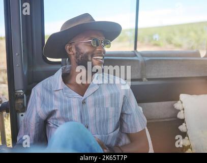Comic, happy and black man on a road trip in van during holiday on the countryside of California. Thinking, relax and free person with smile in car Stock Photo