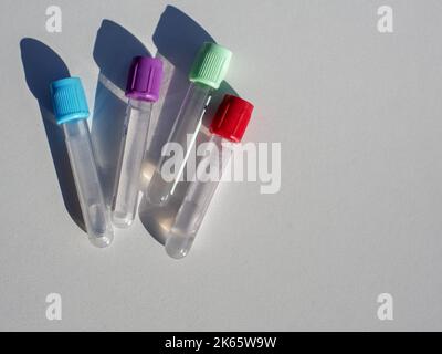 blood collection tubes with colored stoppers, on white background Stock Photo