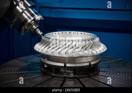 Making turbine wheel with robotized lathe machine at plant Stock Photo