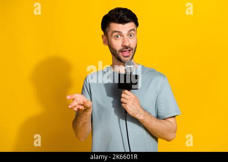 Photo of astonished man stylish clothes communicate ask questions your attitude war empty space isolated on yellow color background Stock Photo