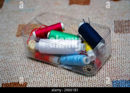 Multicolored sewing threads in a box Stock Photo