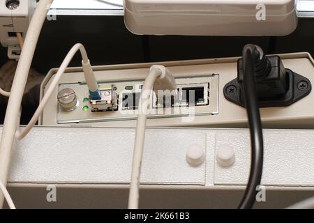 Network computer cables connected to a router or modem in the office Stock Photo