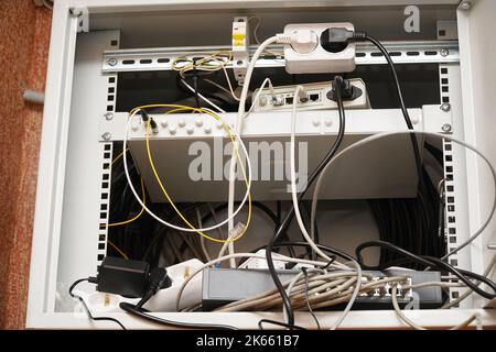 Network computer cables connected to a router or modem in the office Stock Photo